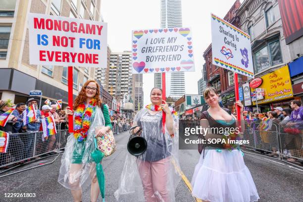 Pro-Polyamory group marching with placards expressing their opinion, during the Toronto LGBTQ Pride Parade.