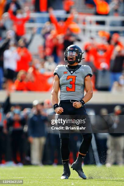 Quarterback Spencer Sanders of the Oklahoma State Cowboys celebrates after throwing a 34-yard touchdown to tight end Jelani Woods against the Iowa...