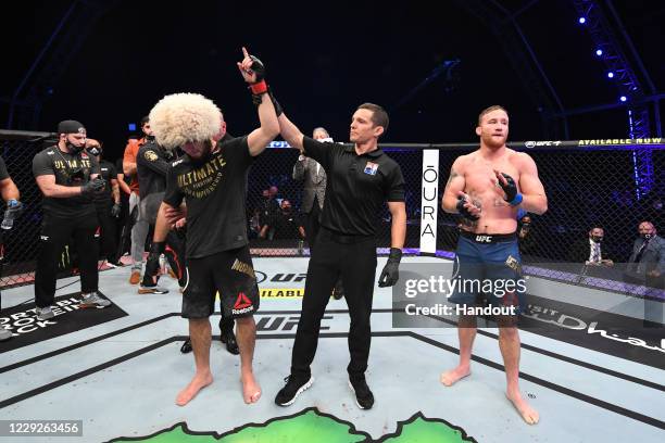 In this handout image provided by UFC, Khabib Nurmagomedov of Russia celebrates his victory over Justin Gaethje in their lightweight title bout...