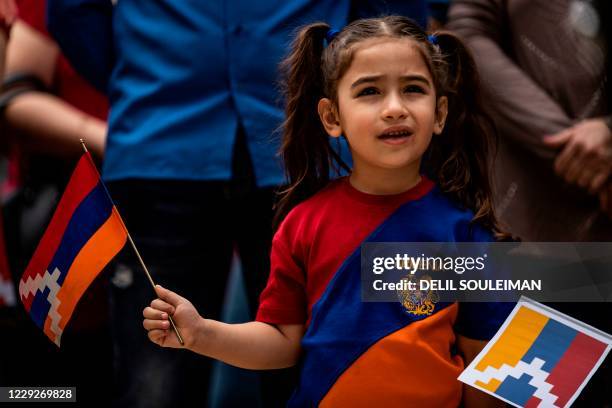 Young girl wears the colours of the Armenian flag as members of Syria's Armenian minority take part in a rally in the Kurdish-majority city of...