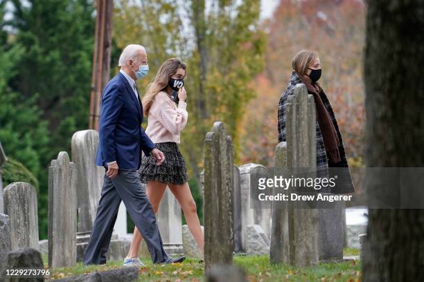 Democratic presidential nominee Joe Biden walks with his granddaughters Natalie Biden and Finnegan Biden as they arrive for Sunday mass at St. Joseph...
