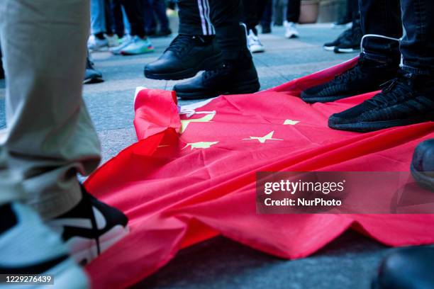 Protesters desecrate the CCP flag during the march to demand the release of 12 Hong Kong detainees in Taipei, Taiwan, on October 25, 2020. Hundreds...