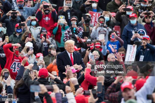President Donald Trump greets supporters at Manchester-Boston International Airport during a campaign rally on October 25, 2020 in Londonderry, New...