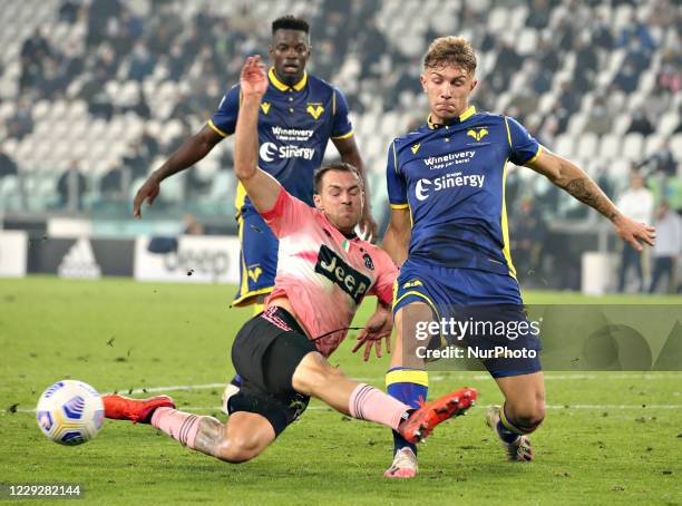 Matteo Lovato of Hellas Verona FC competes for the ball with Aaron Ramsey of Juventus during the Serie A match between Juventus and Hellas Verona FC...