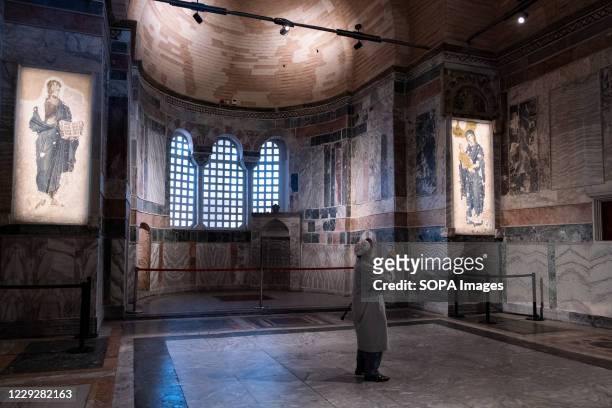 An elderly man takes photos at the Chora Mosque. After the Hagia Sophia, Chora mosque from the Byzantine period the museum status was cancelled with...