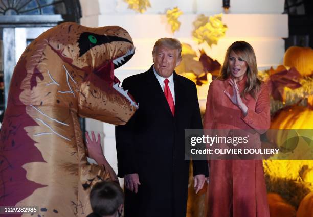 President Donald Trump and First Lady Melania Trump greet trick or treaters during a Halloween celebration at the White House in Washington, DC, on...