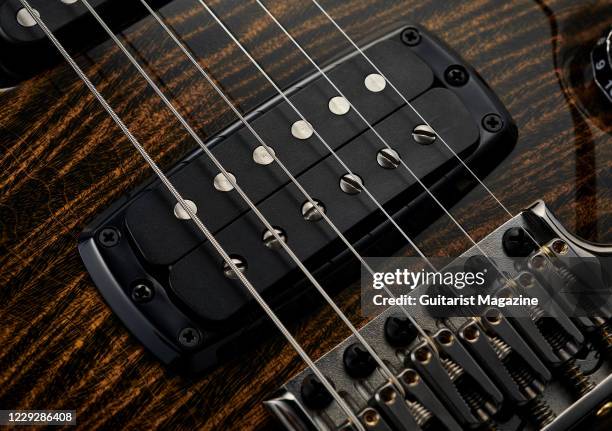 Detail of the pickups on a PRS Private Stock Modern Eagle V Limited Run electric guitar with a Tiger Eye finish, taken on October 4, 2019.