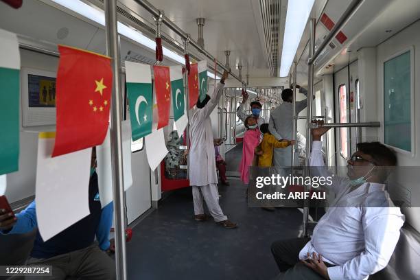 Passengers ride in a newly built Orange Line Metro Train , a metro project planned under the China-Pakistan Economic Corridor , a day after an...