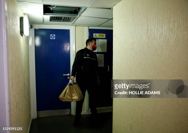 Dom Palacio, Head of Community at Richmond Rugby, delivers meals to local school children living in a block of flats on the Ivybridge estate in...