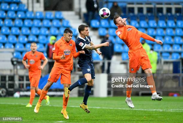 John-Patrick Strauss of Erzgebirge Aue, Simon Zoller of VfL Bochum and Pascal Testroet of Erzgebirge Aue battle for the ball during the Second...