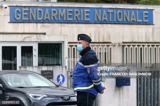 Gendarme looks on as a convoy leaves the gendarmerie Charleville-Mezieres, northeastern France on October 26 en route to Villes-sur-Lume, where...