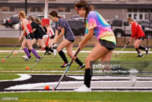 Players on the Sanford High School field hockey team run through a drill on the first day of practice at the school on Tuesday, October 20, 2020.