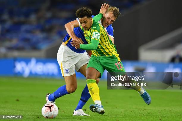 West Bromwich Albion's Brazilian midfielder Matheus Pereira vies with Brighton's English defender Dan Burn during the English Premier League football...
