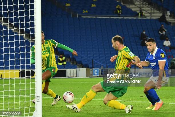 West Bromwich Albion's Serbian defender Branislav Ivanovic hits the ball into West Bromwich Albion's English midfielder Jake Livermore and then into...