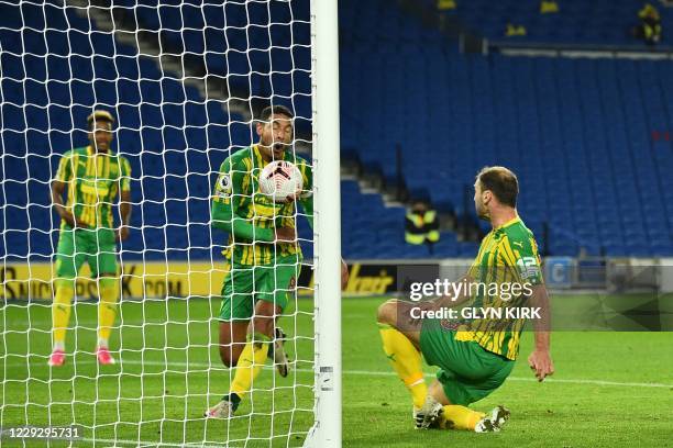 West Bromwich Albion's Serbian defender Branislav Ivanovic hits the ball into West Bromwich Albion's English midfielder Jake Livermore and then into...