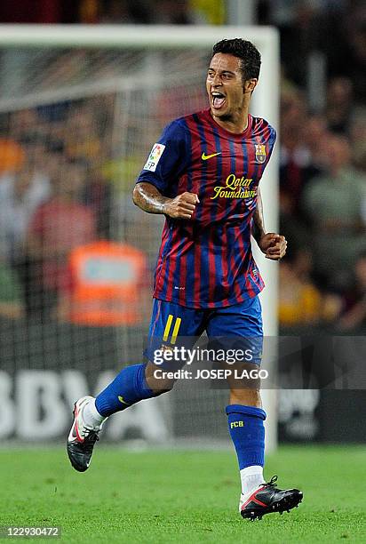 Barcelona's midfielder Thiago Alcantara celebrates after scoring a goal during the Spanish League football match Barcelona vs Villarreal on August...