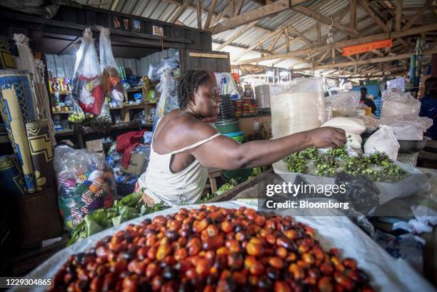 Vendor arranges fresh produce on a stall at a market in Accra, Ghana, on Tuesday, Oct. 23, 2020. Ghana is missing out on a rally of African bonds as...