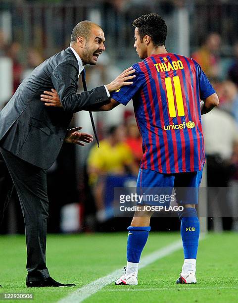 Barcelona's coach Josep Guardiola speaks with Barcelona's midfielder Thiago Alcantara during the Spanish league football match Barcelona vs...