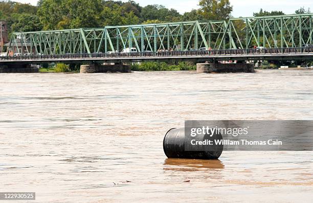 Barrel floats down the Delaware River after flood waters crest from Tropical Storm Irene August 29, 2011 in Lambertville, New Jersey. Major flooding...