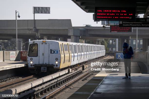 Person waits on a platform at a Bay Area Rapid Transit train station in Oakland, California, U.S., on Monday, Oct. 26, 2020. BART is facing a...