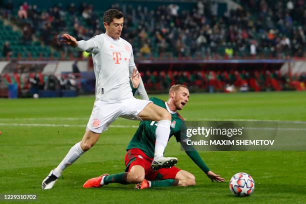 Bayern Munich's Polish forward Robert Lewandowski and Lokomotiv Moscow's Russian midfielder Vladislav Ignatyev vie for the ball during the UEFA...