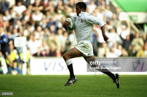 Jeremy Guscott of England runs in an 80m intercepted try in the Rugby World Cup Pool B match against Tonga at Twickenham in London. England won...