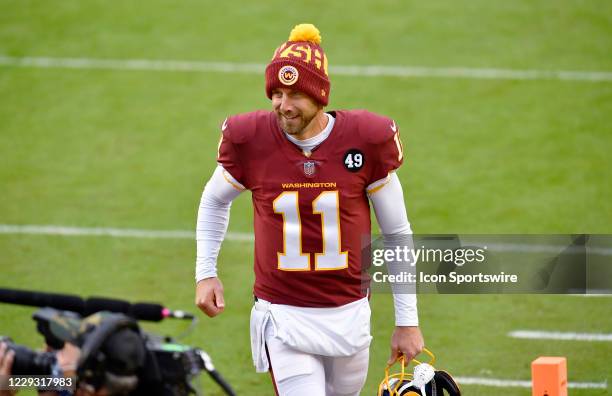 Washington quarterback Alex Smith runs off the field during the Dallas Cowboys vs. Washington Football Team NFL game at FedEx Field on October 25,...