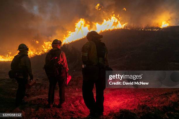 Firefighters set a backfire to protect homes and try to contain the Blue Ridge Fire on October 27, 2020 in Chino Hills, California. Strong Santa Ana...