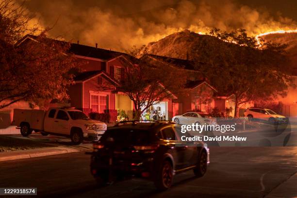 Flames come close to houses during the Blue Ridge Fire on October 27, 2020 in Chino Hills, California. Strong Santa Ana Winds gusting to more than 90...