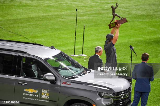 Corey Seager of the Los Angeles Dodgers hoists up the World Series MVP trophy after the Dodgers defeated the Tampa Bay Rays in Game 6 of the 2020...