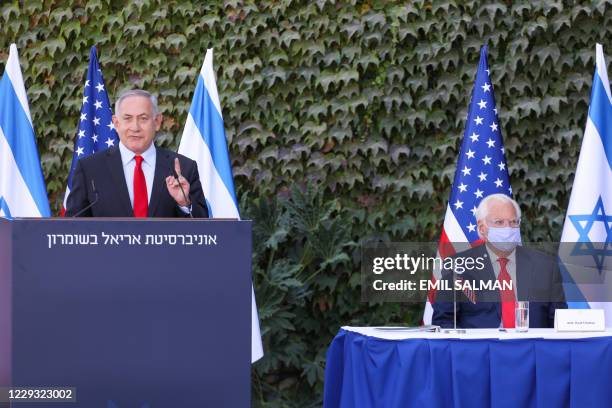 Ambassador to Israel David Friedman listens to a speech by Israeli Prime Minister Benjamin Netanyahu during a ceremony for the signing of an...