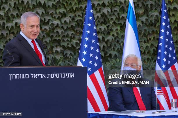 Ambassador to Israel David Friedman listens to a speech by Israeli Prime Minister Benjamin Netanyahu during a ceremony for the signing of an...