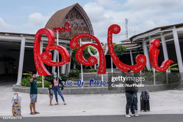 Domestic passengers takes selfie as they arrives during long holiday season amid COVID-19 pandemic at arrival domestic terminal of I Gusti Ngurah Rai...