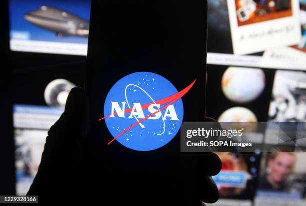 In this photo illustration a NASA logo seen displayed on a smartphone.