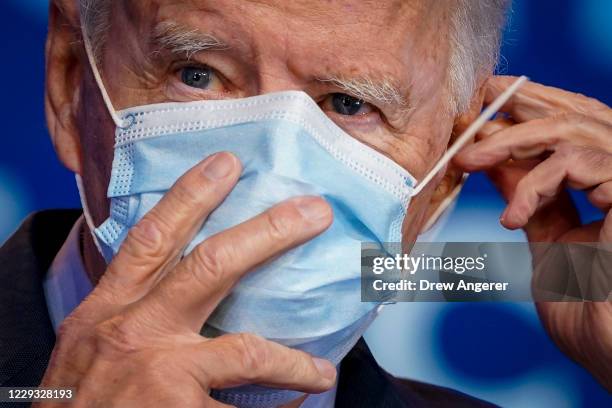 Democratic presidential nominee Joe Biden puts on his face mask after making remarks about the Affordable Care Act and COVID-19 after attending a...