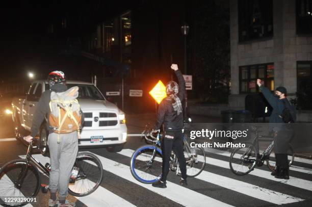 Protesters provide their own traffic control in leu of traditional police escorts through the city as they march from Malcolm X Park to Clark Park in...