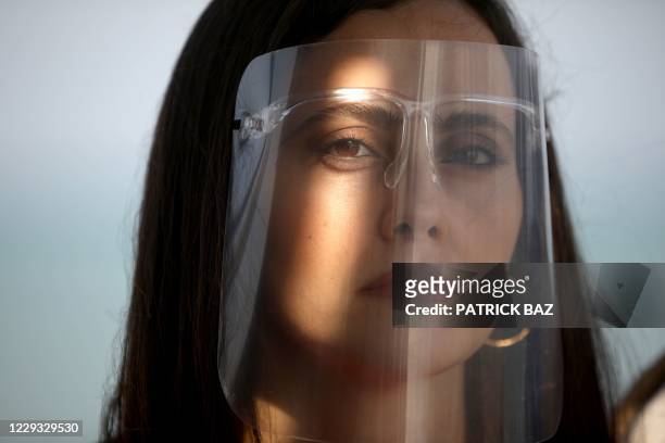 Lebanese film maker Farah Shaer poses with her protective shield during a photos shoot at the El Gouna Film Festival in the Red Sea southern resort...