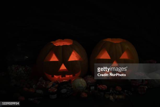 Two candle lit jack-o'-lanterns in a bakery in Athens. On October 27, 2020 in Athens, Greece. Halloween is not actually celebrated by the Greeks, but...