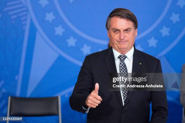 Jair Bolsonaro, President of Brazil, gestures during Civil Servant Day Ceremony amidst the coronavirus pandemic at the Planalto Palace on October 28,...