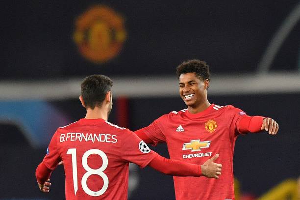 Manchester United's English striker Marcus Rashford celebrates scoring his team's third goal, his second, with Manchester United's Portuguese...