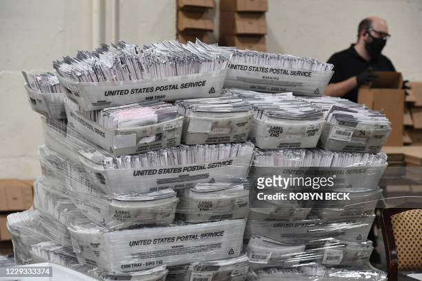 Mail-in ballots in their envelopes await processing at the Los Angeles County Registrar Recorders' mail-in ballot processing center at the Pomona...