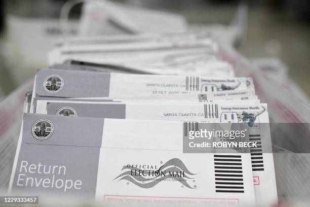 Mail-in ballots in their envelopes await processing at the Los Angeles County Registrar Recorders' mail-in ballot processing center at the Pomona...
