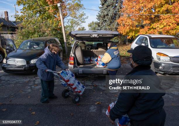 Volunteers help distribute water at Asbury United Methodist Help Center in Flint, Michigan, October 20,2020. - Authorities say Flint's water meets...