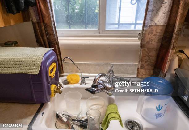Water storage container used by Cleophus Mooney and his family for clean drinking water in his home in Flint, Michigan, October 22,2020. Flint,...