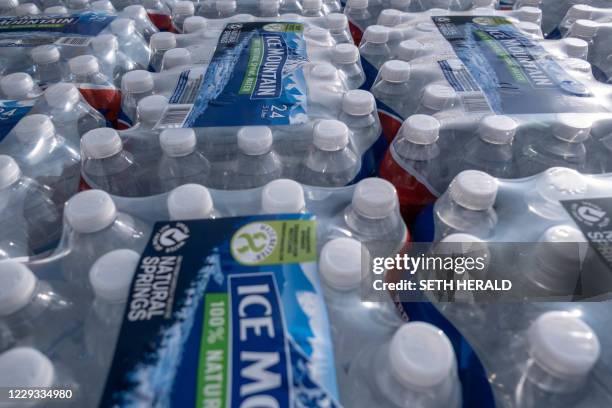 Cases of water are distributed to Flint area residents at Asbury United Methodist Help Center in Flint, Michigan, October 20,2020. The area is still...