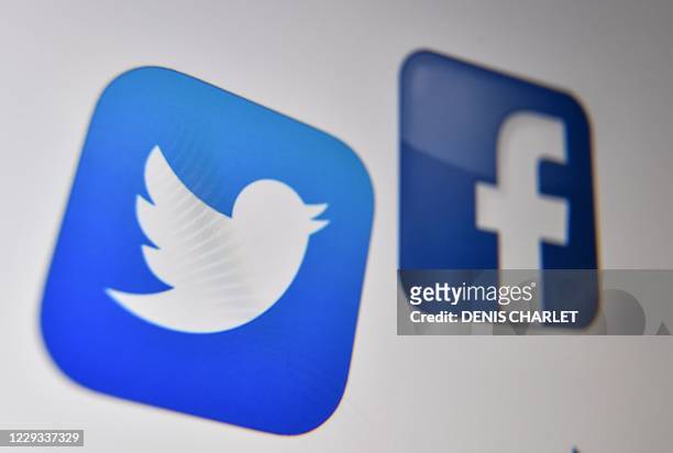 Photo taken on October 21, 2020 shows the logo of the the American online social media and social networking service, Facebook and Twitter on a...