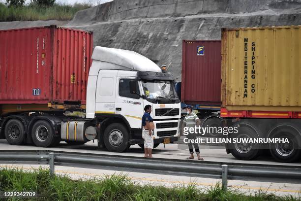 Truckers wait for inspections along the road leading to the Ministry of Transport in front of the border crossing at the second Thai-Myanmar...