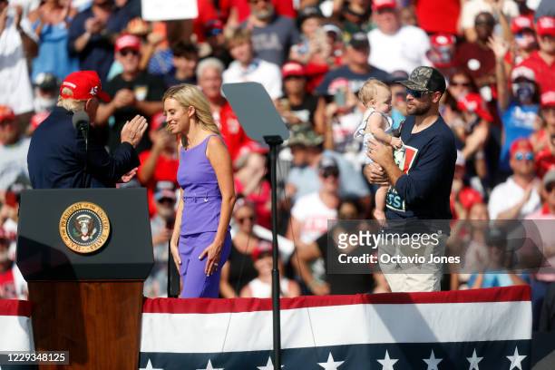 White House Press Secretary Kayleigh McEnany smiles while on her stage with her husband Sean Gilmartin and their daughter during President Donald...