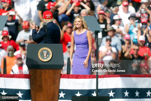 White House Press Secretary Kayleigh McEnany smiles when acknowledged by President Donald Trump during his campaign speech just four days before...