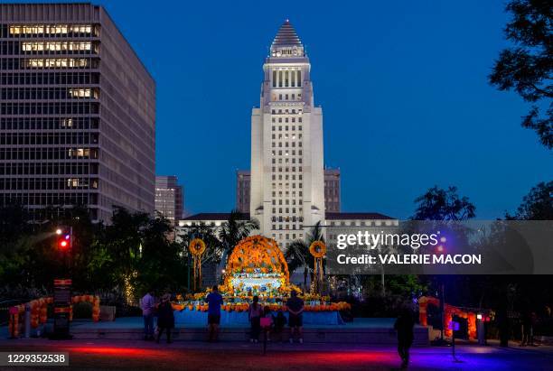 Los Angeles City Hall is seen behind an altar during a socially distant public art installation put together by The Music Center for Grand Park's 8th...